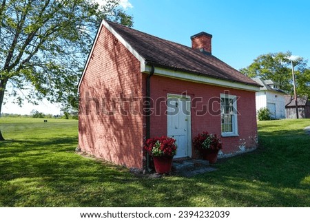 Tiny brick home with flower boxes Royalty-Free Stock Photo #2394232039