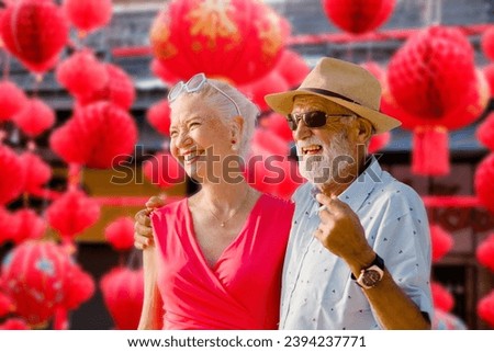 Traditional Festive Travel: Senior Couple Immersed in Chinese New Year Red Lanterns - Exploring Cultural Celebrations Royalty-Free Stock Photo #2394237771