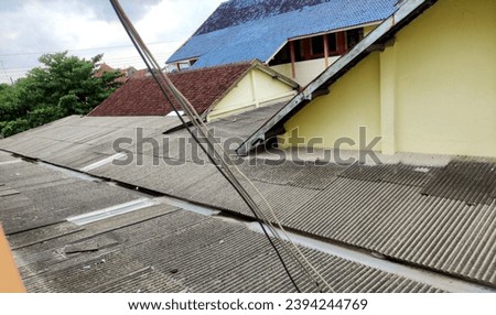 Asbestos roof. Asbestic tiles on the roof Royalty-Free Stock Photo #2394244769