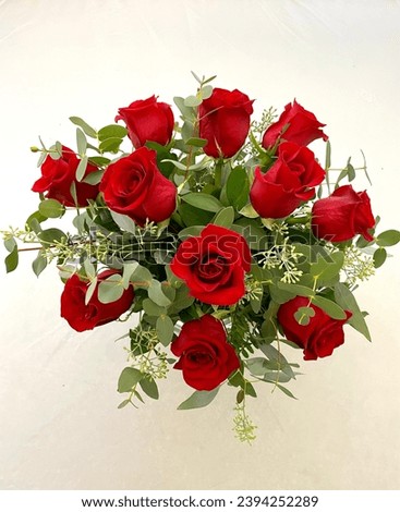 Red dozen rose arrangement with eucalyptus  Royalty-Free Stock Photo #2394252289