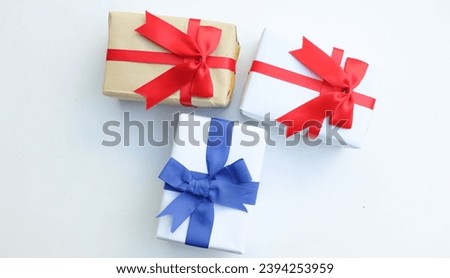 Stack of vintage or handmade gift boxes with blue,red ribbon bow isolate on a white backdrop.
