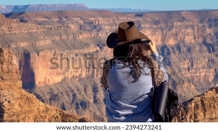 Young woman is overwhelmed by view over the Grand Canyon - travel photography