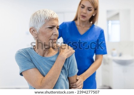 Doctor or Physiotherapist working examining treating injured arm of senior patient, stretching and exercise, Doing the Rehabilitation therapy pain in clinic.