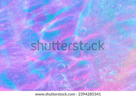 Beautiful neon purple, pink and blue transparent space alien glitter slime background texture. Sparkle cosmic, surreal abstract backdrop, ethereal, liquid art gel galaxy substance. Royalty-Free Stock Photo #2394285341