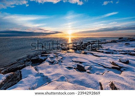 The coast of the Gulf of Finland in winter at sunset Royalty-Free Stock Photo #2394292869