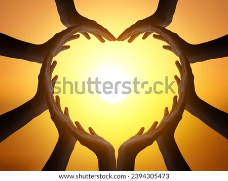 Many people hands in shape of heart on blurred beautiful sunset background Royalty-Free Stock Photo #2394305473