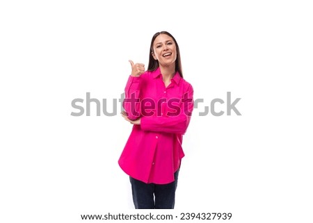 cheerful bright caucasian woman with black straight hair is dressed in a crimson oversized shirt