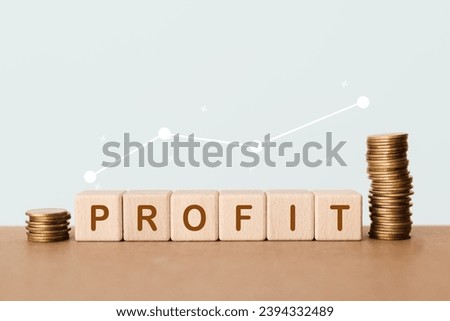 PROFIT text on wooden cube blocks between stack of coins and increasing graph for business or finance management, financial target, business growth