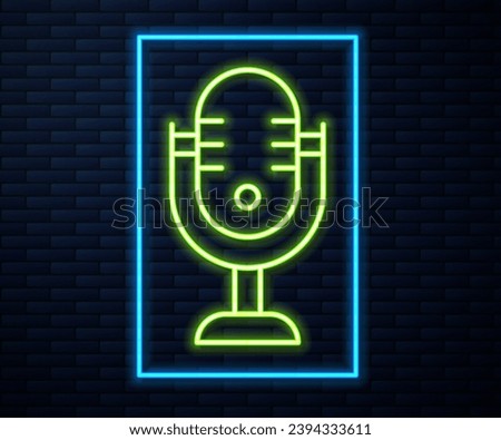 Glowing neon line Microphone icon isolated on brick wall background. On air radio mic microphone. Speaker sign.  Vector