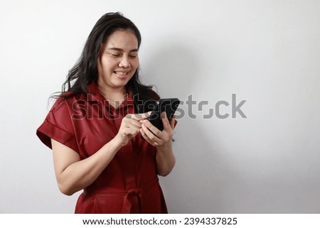 Woman using phone on gray background, woman holding smartphone 
