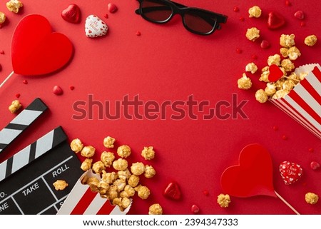 Romantic Cinema Snapshot: top view photo of a clapperboard, 3D glasses, popcorn, chocolates, sprinkles and heart on sticks, adorning a red background, hinting at a love-filled movie premiere