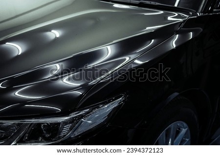 Car details - front black car hood. Royalty-Free Stock Photo #2394372123