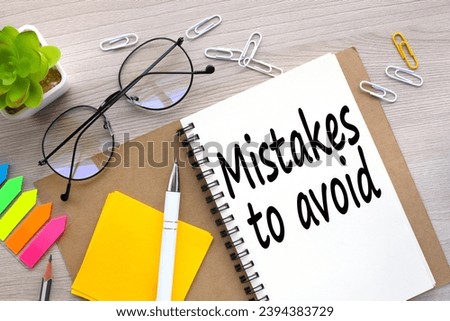 Mistakes To Avoid open notepad with text. bright stickers point to text Royalty-Free Stock Photo #2394383729