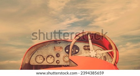 Rear view of a classic French sports car of the early twentieth century in front of a blue cloudy sky Royalty-Free Stock Photo #2394385659