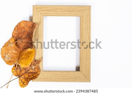 Autumn composition. Photo frame, maple leaves, on white background. Flat lay, top view, copy space.