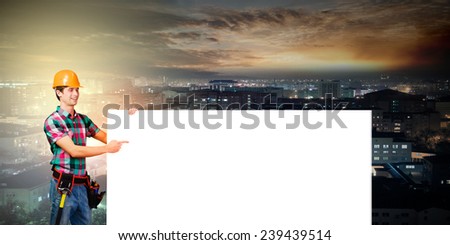 Young repairman with white blank banner. Place for text