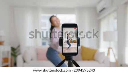 Asia vlogger woman influencer smile enjoy hobby happy fun live online screen  reel  at home Gen Z teen girl talent people play video selfie camera shoot  app show share viral story Royalty-Free Stock Photo #2394395243