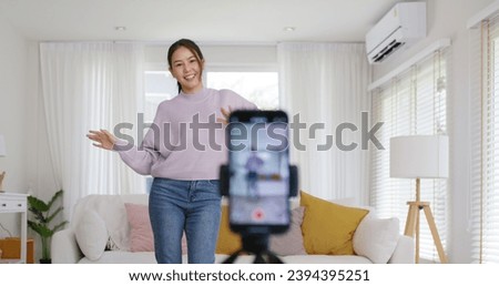 Asia vlogger woman influencer smile enjoy hobby happy fun live online screen  reel  at home Gen Z teen girl talent people play video selfie camera shoot  app show share viral story Royalty-Free Stock Photo #2394395251