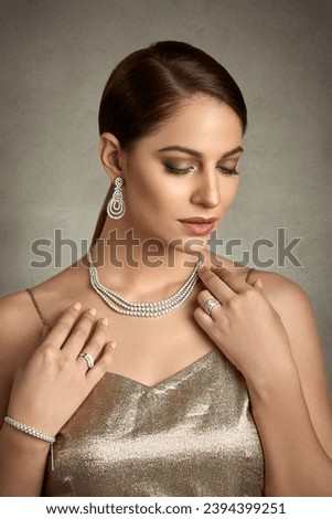 Beautiful Indian model wearing a diamond necklace  Royalty-Free Stock Photo #2394399251