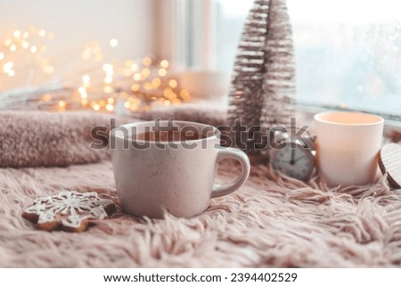 Cup of tea with steam in winter morning atmosphere.