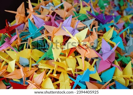 Colorful many origami paper cranes on a white background. High quality photo