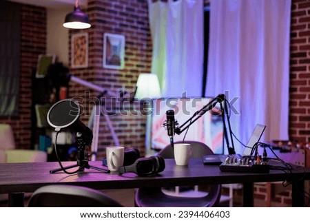 Empty home production studio with podcast equipment technology recording sound for streaming site entertainment show. Live broadcasting cozy location in living room with rgb lights