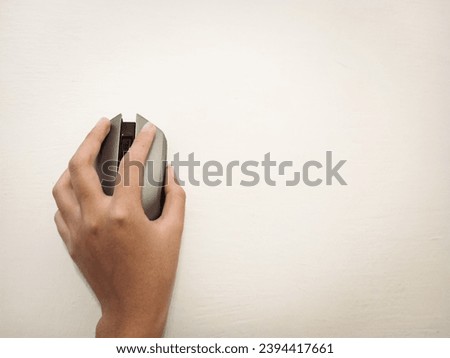 a picture of hand holding a wireless mouse.