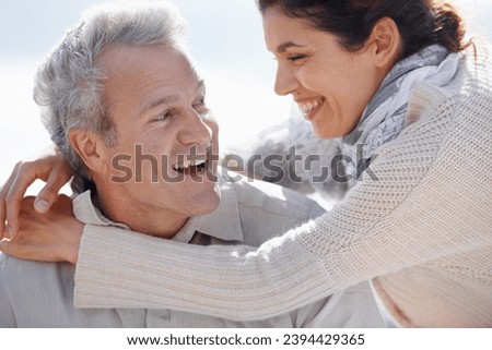 Couple, face and laughing outdoor with hug for romance, love and relationship in nature with relaxing. Mature, man and woman or embrace with happy, playful and joy for bonding, honeymoon and support Royalty-Free Stock Photo #2394429365