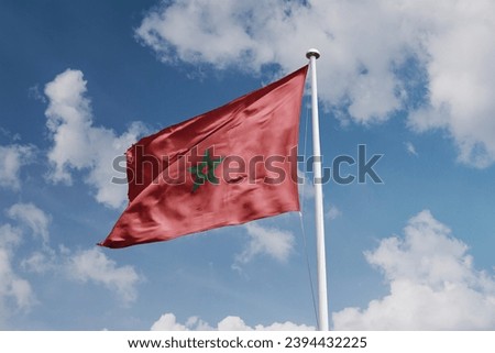 Moroccan flag waving in the beautiful sky.