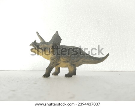 Triceratop miniature with white background. Dinosaurs toy. Close-up view