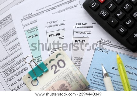 Declaration of the amount of earned income or incurred loss, PIT-36, PIT-36L, PIT-37 and PIT-38 tax forms on accountant table with pen and polish zloty money bills close up Royalty-Free Stock Photo #2394440349