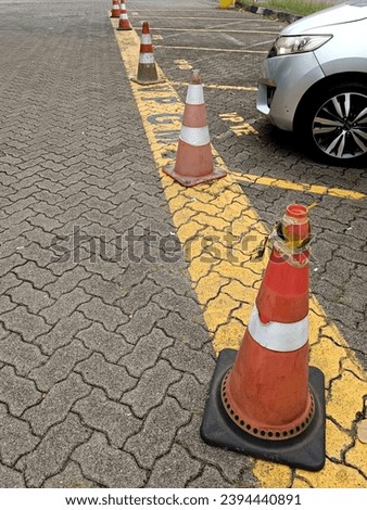 Traffic cones standing in a row in the parking lot