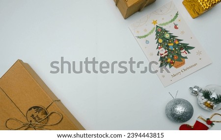 Christmas elements isolated on a white background, with a holiday greeting card with a picture of a snowman and a holiday greeting card with a picture of a christmas tree. Christmas ornaments with gre