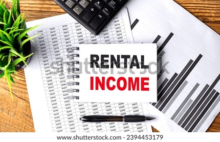 RENTAL INCOME text on notebook with chart and calculator