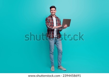 Full length photo of charming cool guy wear checkered shirt texting apple samsung modern device isolated teal color background