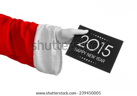 Christmas and New Year theme: Santa's hand holding a black card with New Year Greetings 2015 on a white background isolated