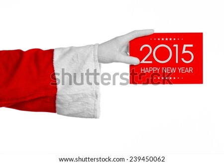 Christmas and New Year theme: Santa's hand holding a red card with New Year Greetings 2015 on a white background isolated