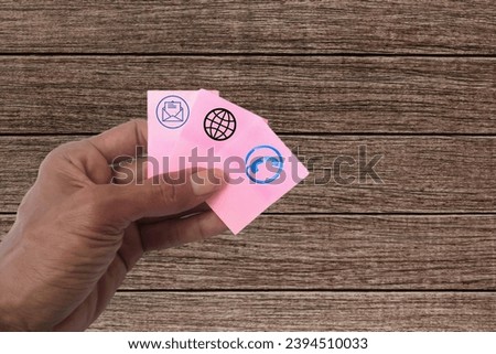 hand holding telecommunication card and network wood grain background