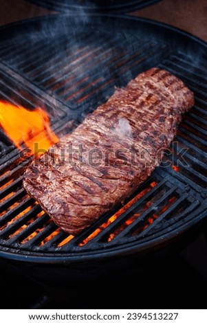 Traditional American barbecue bavette steak as close-up on a charcoal grill with fire  Royalty-Free Stock Photo #2394513227