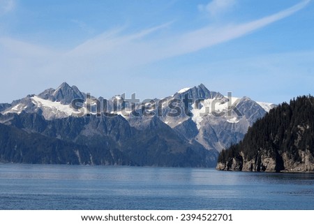 Landscape on the Alaskan coast, in the background the mountain range of the Kenai Fjords National Park Royalty-Free Stock Photo #2394522701