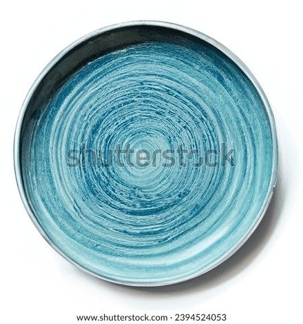Empty blue ceramic plate isolated on white background. Top view, flat lay, close up.
