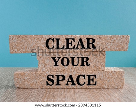 Clear your space symbol. Brick blocks with words Clear your space. Beautiful blue background, wooden table. Business, clear your space concept, copy space.