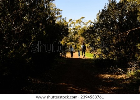 Mom walking with her children in the forest