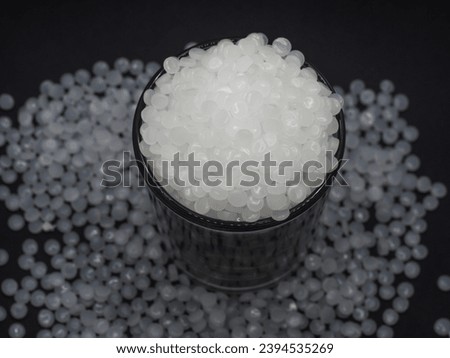 High density polyethylene plastic granules on a black background, this virgin polymer is one of the basic materials in the plastics industry Royalty-Free Stock Photo #2394535269