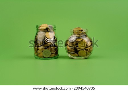 Saving coins in a glass jar Finance, banking, investments, financial growth Financial income, cash flow, income and expenses