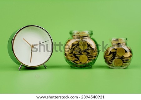 Saving coins in a glass jar Finance, banking, investments, financial growth Financial income, cash flow, income and expenses