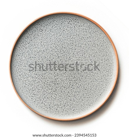 Empty beige plate isolated. on white  background. Top view, flat lay. Textured object, selective focus. Royalty-Free Stock Photo #2394545153