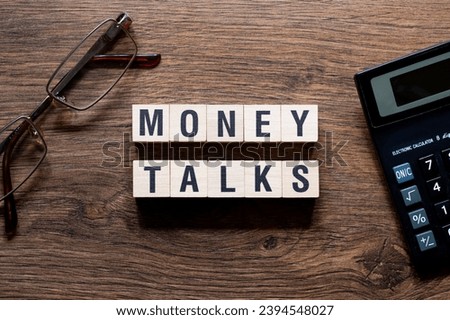 Money talks - word concept on building blocks, text, letters Royalty-Free Stock Photo #2394548027