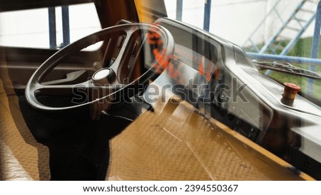 The cab of the world's largest dump truck. Steering wheel, dashboard and other controls. Payload 450 tonnes. View through the glass Royalty-Free Stock Photo #2394550367