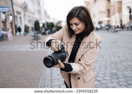 Process of female photographer making photo in the centre of the city 